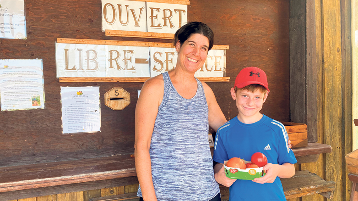 Nancy Gélinas a pu compter sur l’aide de son fils Elliot, 8 ans, pour s’occuper du kiosque libre-service de la Ferme Gélijean. Photos : Émilie Parent-Bouchard